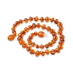 Polished teething amber necklace cognac color