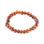 Polished amber beaded bracelet with natural inclusions on elastic, perfect for everyday or special wear.