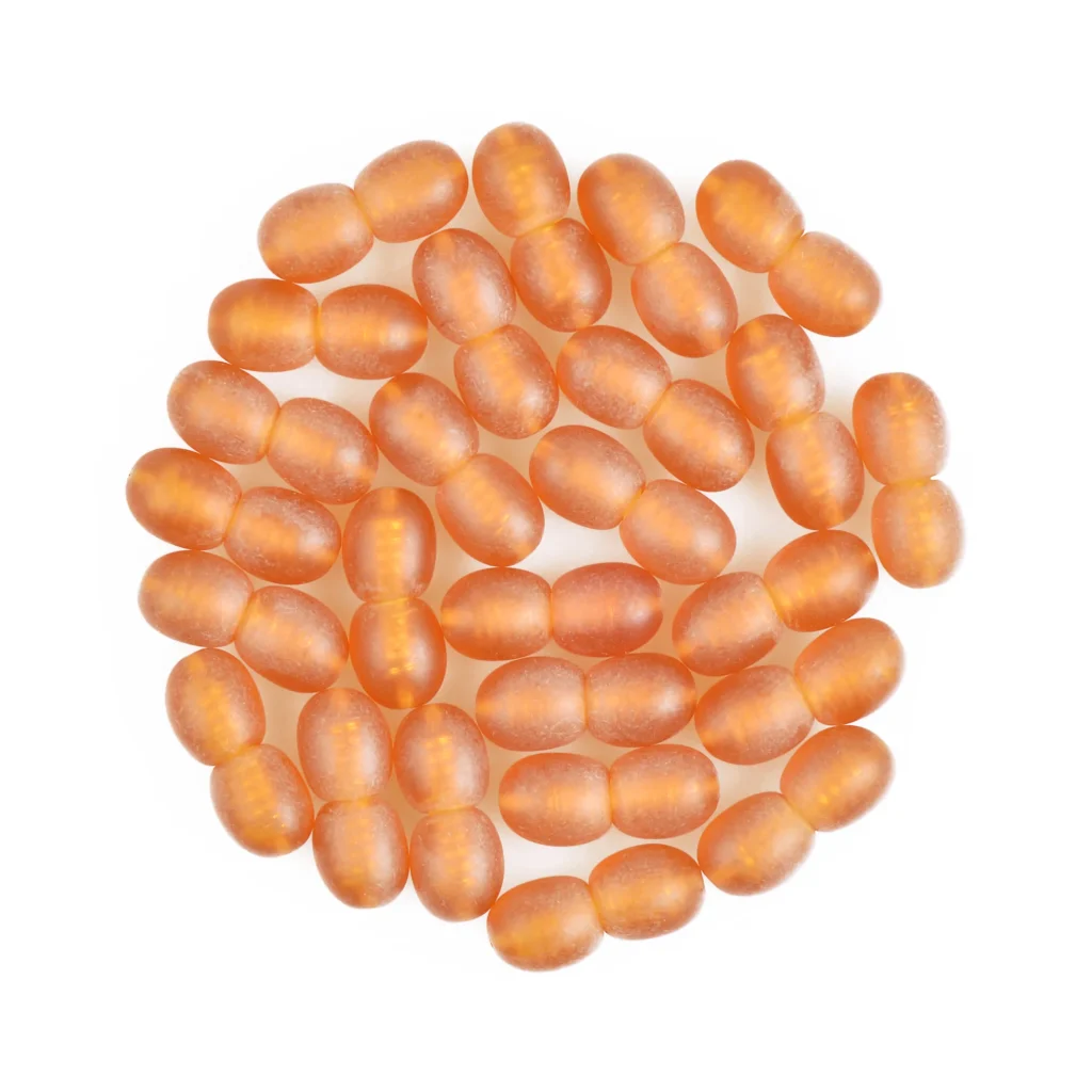 Collection of amber-colored dietary supplement capsules arranged in a circular pattern.