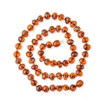 Handmade Baltic amber necklace with warm cognac beads, showcasing natural beauty and artisanal craftsmanship.