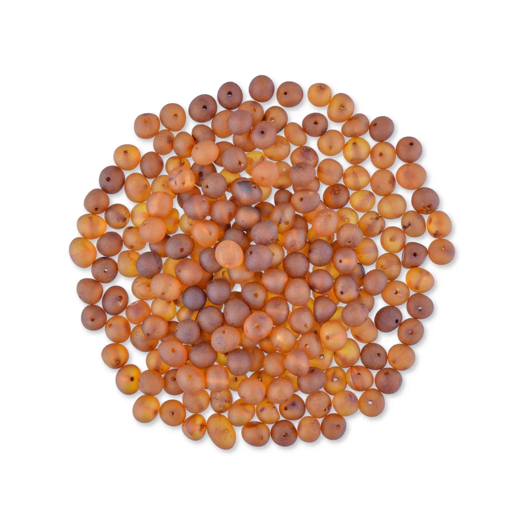 Natural Baltic amber beads in warm cognac tones with glossy, smooth beads arranged in a circular pattern.