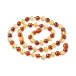 Elegant Baltic amber necklace with varied polished beads in warm, natural tones and timeless style.