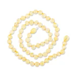 Handmade Baltic amber necklace with natural honey-colored beads and elegant spiral design.