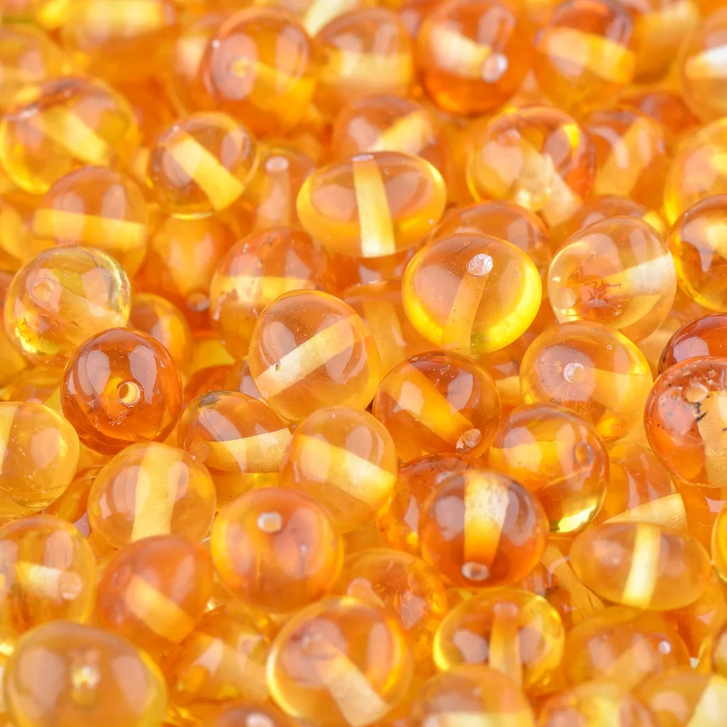 Shimmering amber beads with warm honey tones, perfect for jewelry and creative crafts.