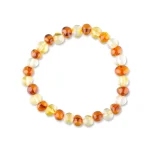 Beaded Baltic amber bracelet with warm tones on stretchy elastic for versatile, elegant wear.