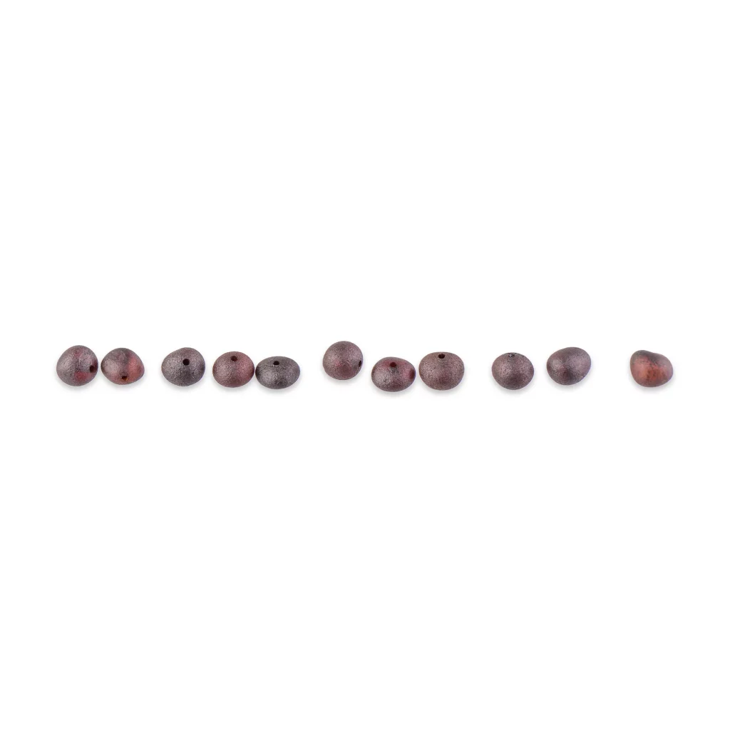 Row of polished purple and maroon gemstone beads with central holes for jewelry-making.