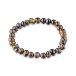 Handcrafted beaded bracelet with dark brown, black, amber, and gold hues on elastic stretch.