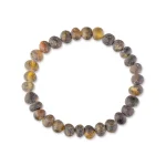 Handmade natural gemstone beaded bracelet with earthy tones and polished, organic design.