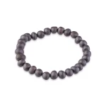 Rustic dark wooden beaded bracelet on elastic cord, versatile and naturally stylish accessory.