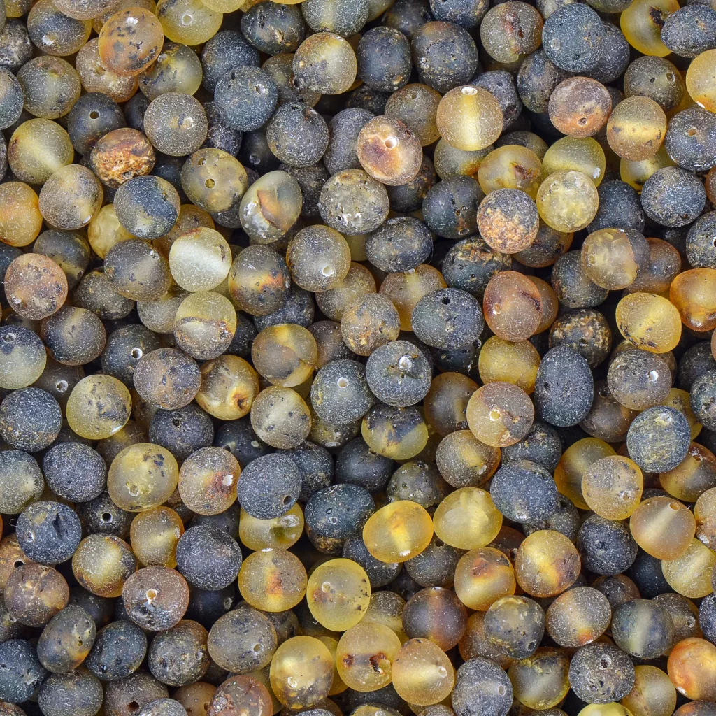 Close-up of colorful, glossy beads with natural textures and organic patterns.