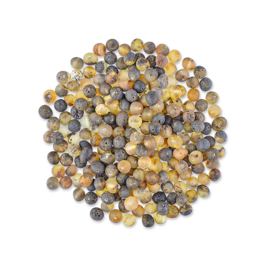 Colorful collection of round Baltic amber beads with diverse textures and natural hues arranged in a circle.