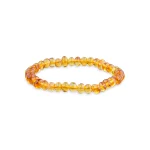 Elegant amber beaded bracelet with polished, warm-toned Baltic amber on stretch elastic.