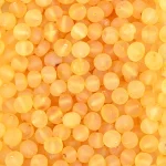 Close-up of warm amber beads with a glowing, translucent, honey-colored finish.