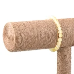 Yellow beaded bracelet draped over natural sisal-wrapped cat scratching post.
