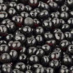 Close-up of glossy black beads with subtle red highlights, ideal for jewelry and craft projects.