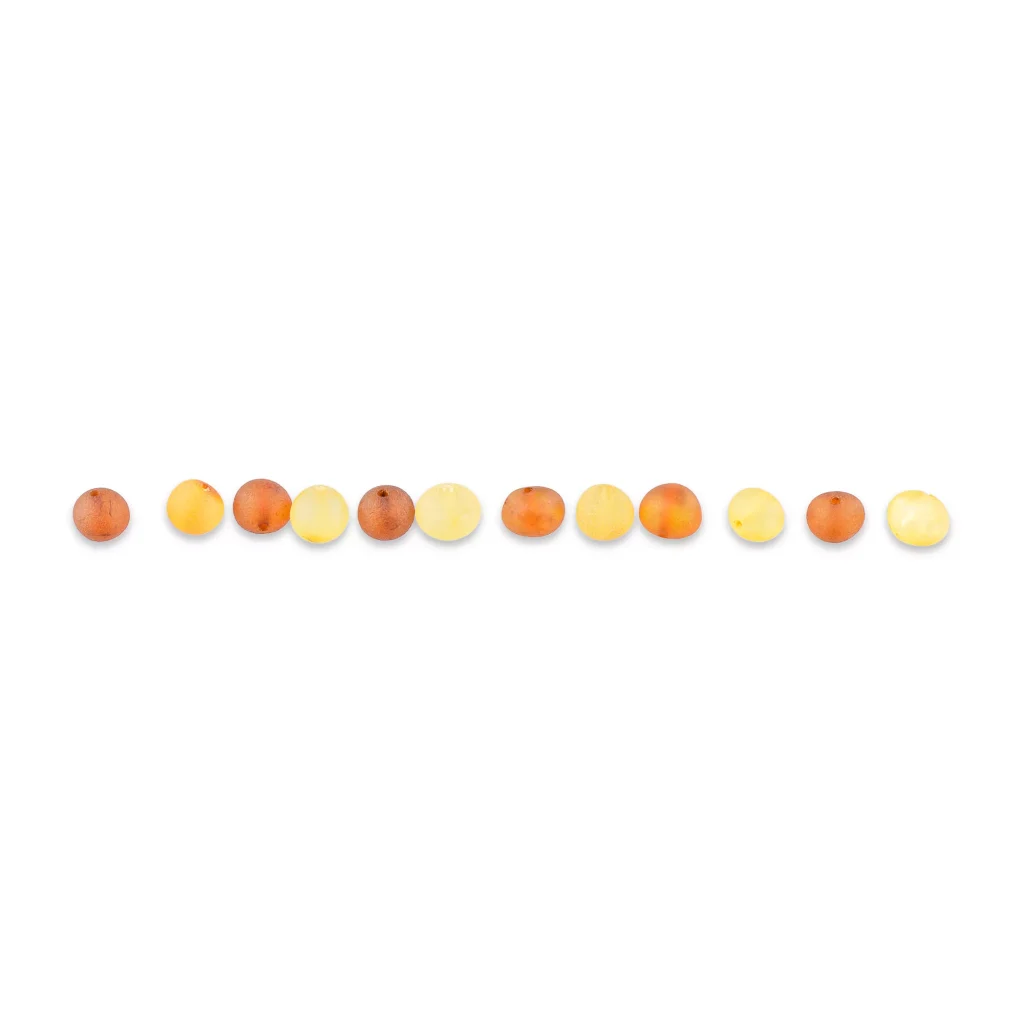 Line of gradient-colored amber beads with glossy, circular surfaces reflecting light.