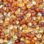 Colorful, shiny amber beads with warm tones and handcrafted irregular shapes for jewelry making.
