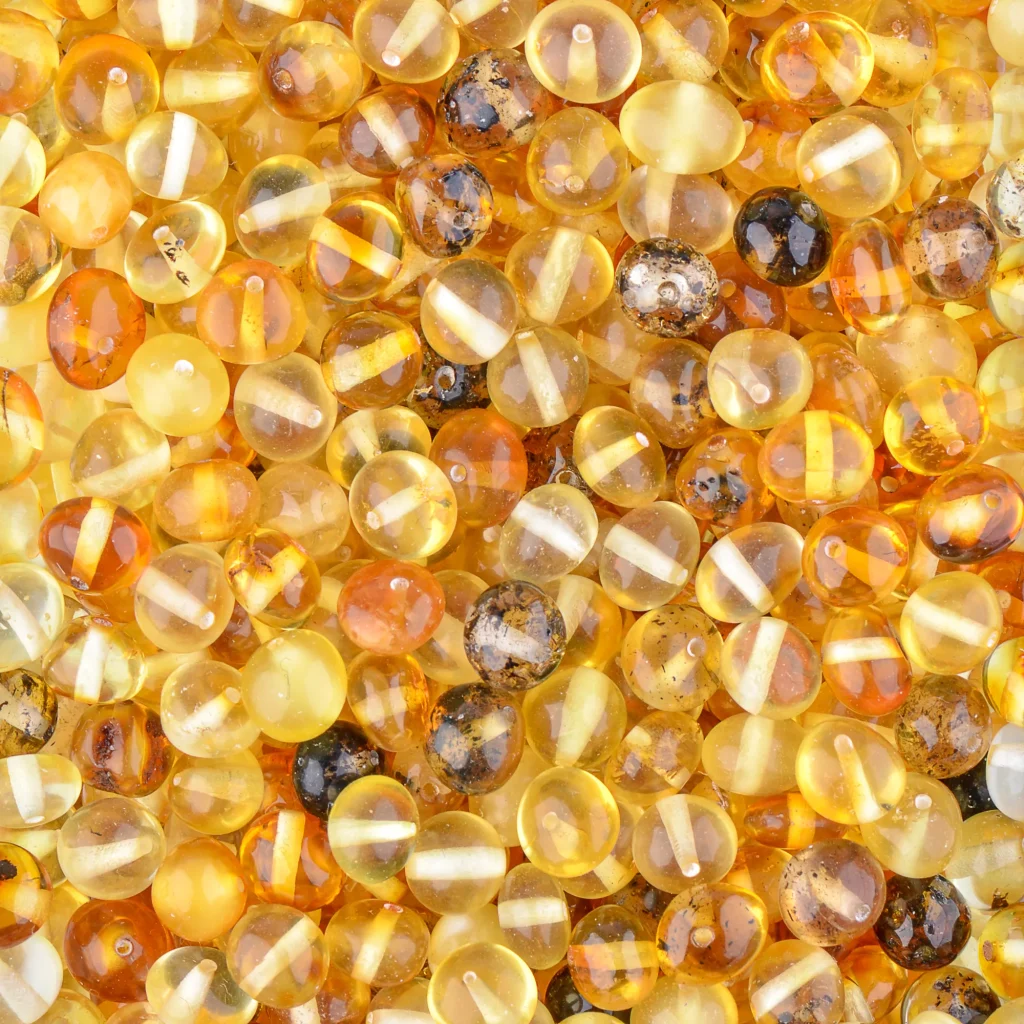 Vibrant Baltic amber beads in warm yellow and chestnut tones with glossy, polished surfaces.