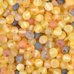 Colorful resin beads in warm yellow, orange, and black tones with glossy, translucent finishes.