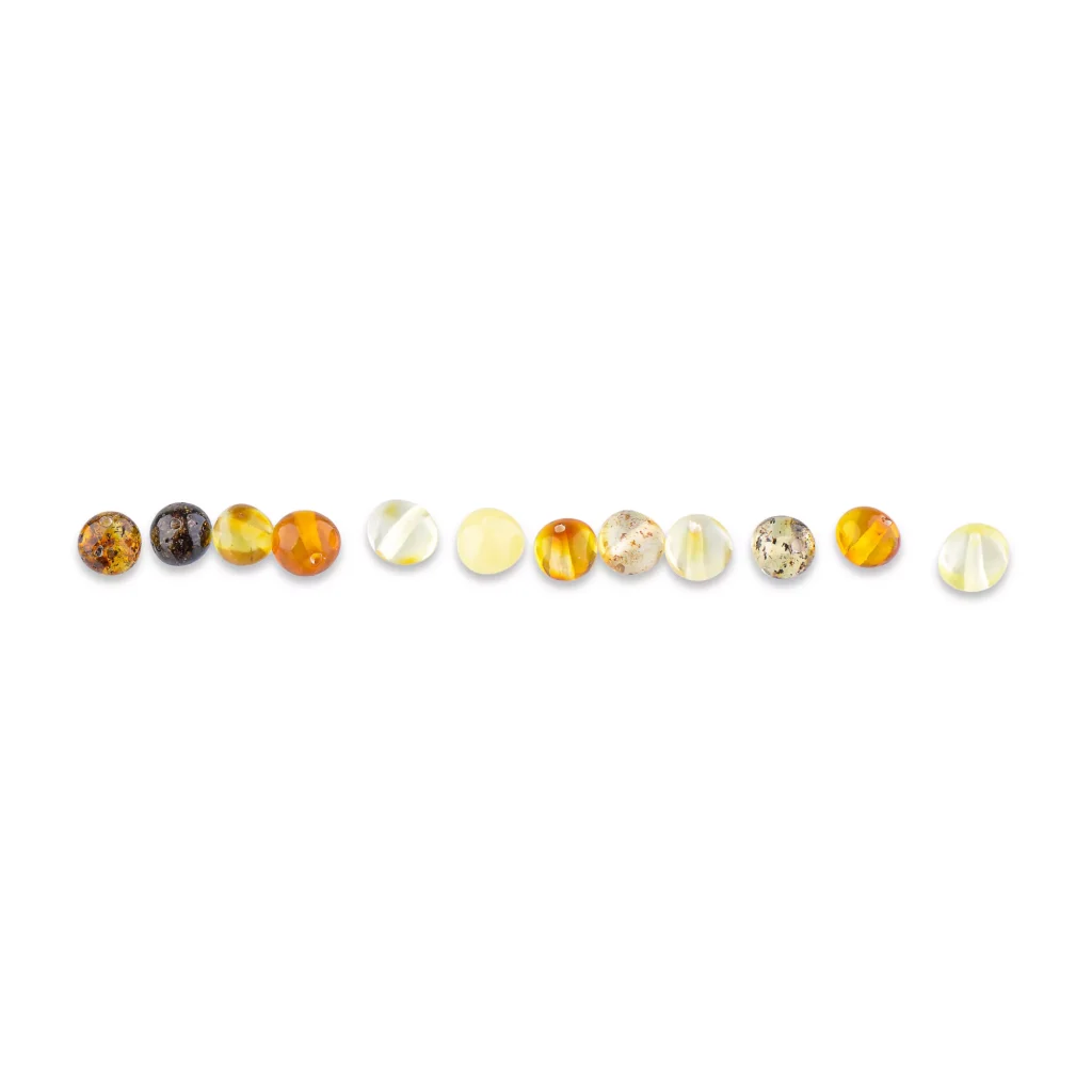 Line of polished Baltic amber beads in warm natural tones, showcasing handcrafted elegance and organic beauty.