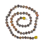 Handmade earthy Baltic amber necklace with textured beads and vibrant focal bead.