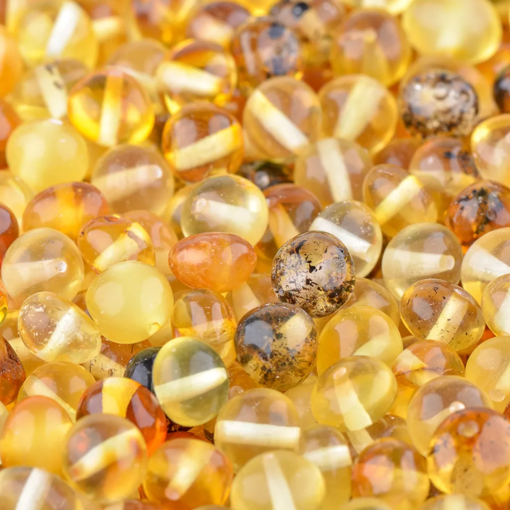 Handcrafted Baltic amber beads with natural variations, warm colors, and organic textures for jewelry.