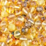 Handcrafted Baltic amber beads with natural variations, warm colors, and organic textures for jewelry.