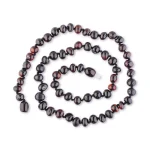Handcrafted red and black beaded necklace with glossy, natural stone finishes for elegant style.
