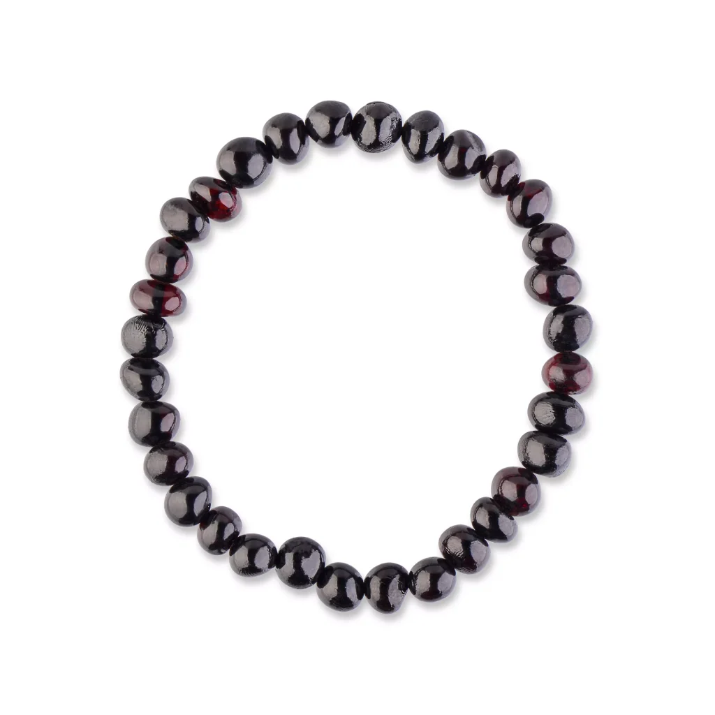 Black beaded bracelet made from polished onyx or obsidian, elegant and versatile jewelry accessory.