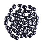 Shiny black beans arranged neatly, showcasing smooth texture and glossy finish in a minimalist design.