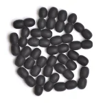 Collection of matte black oval beads with smooth, velvety texture on white background.