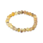 Handcrafted amber beaded bracelet with warm golden tones and polished, earthy, natural aesthetic.