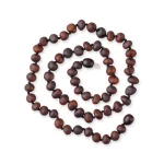 Handcrafted wooden mala necklace spiraled for meditation, featuring earthy tones and natural craftsmanship.