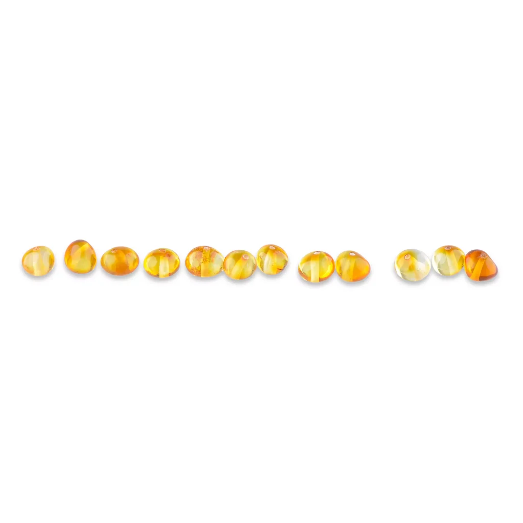 Line of polished Baltic amber beads in warm honey and amber tones.