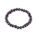 Elegant black beaded bracelet with polished onyx-like gemstones on elastic stretch band.