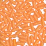 Close-up of orange capsules clustered together, showcasing their uniform shape and matte finish.