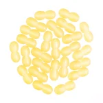 Collection of yellow oval pills or candies with glossy, two-lobed shapes and cheerful appearance.