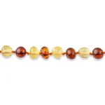 Handmade amber necklace with warm, earthy tones and polished, glossy beads in natural Baltic amber.
