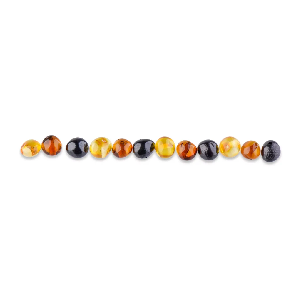 Row of glossy multicolor Baltic amber beads with natural warm tones and smooth oval shapes.