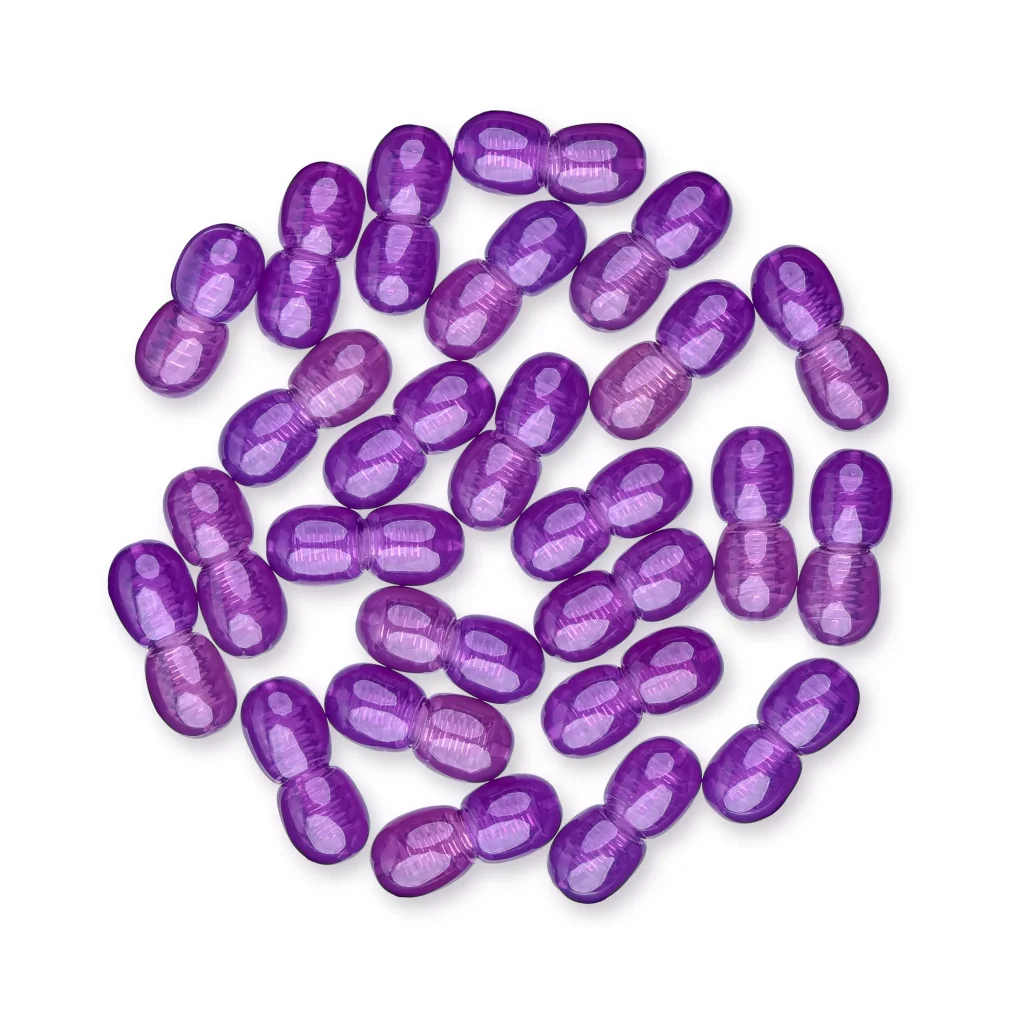 Collection of shiny purple capsules arranged in a circular pattern against a plain background.