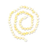 Handmade yellow amber spiral necklace with polished, textured oval beads and warm, inviting glow.