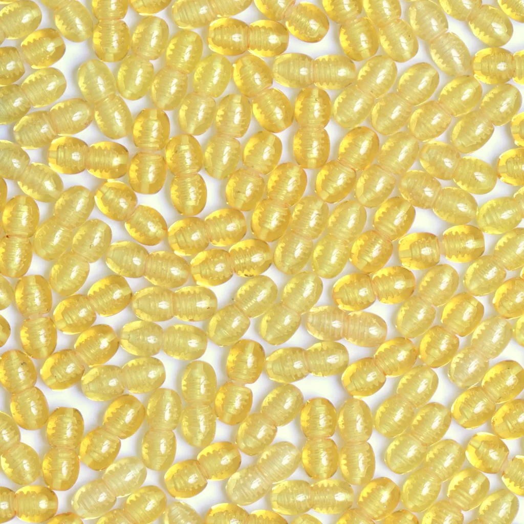 Vibrant yellow glossy oval beads for jewelry, crafts, or decorative purposes.