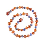 Polished teething amber necklace cognac color with sodalite