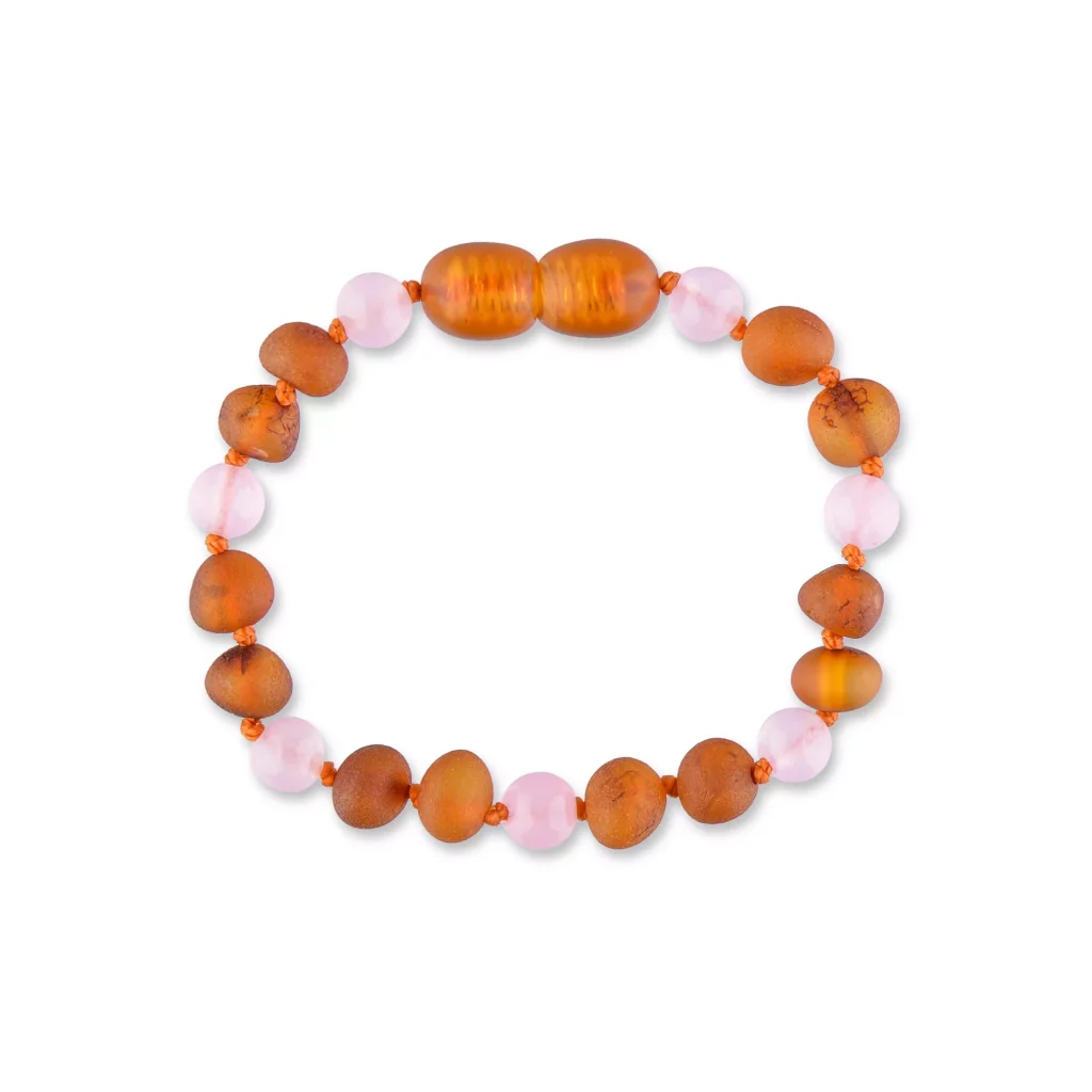 Handmade amber and pink beaded bracelet with warm tones and textured, glossy accents.