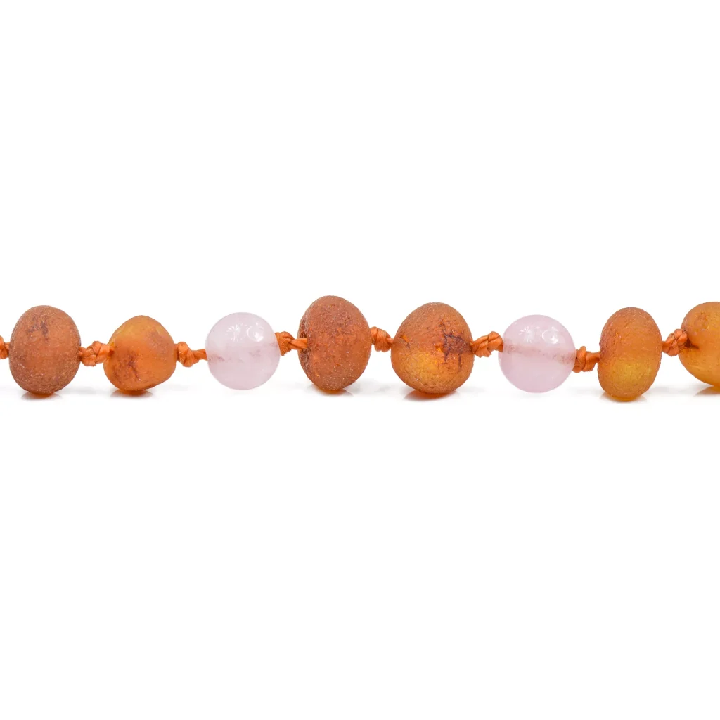 Warm orange and pink beaded necklace with polished Baltic amber and rose quartz accents.