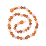 Handmade amber and pink bead necklace with focal amber center and handcrafted charm.