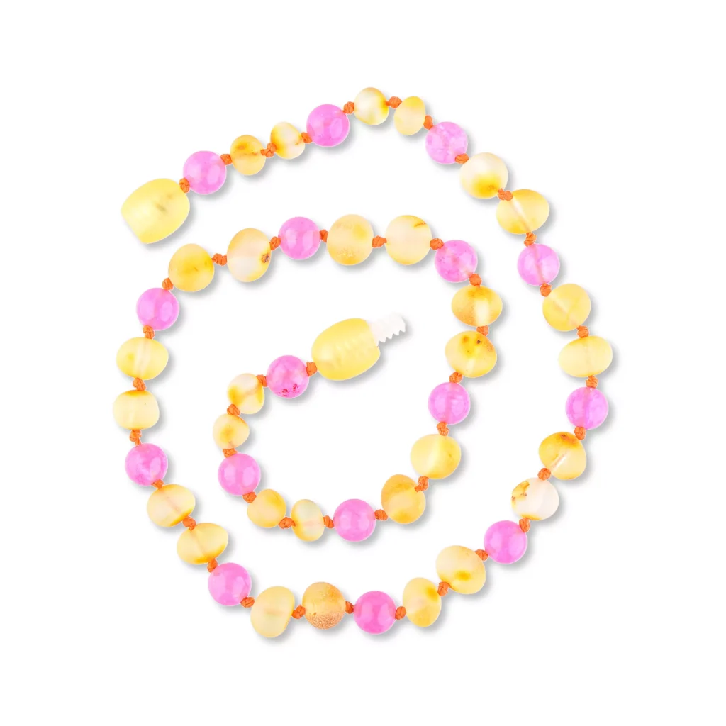 Colorful beaded necklace with yellow and pink glossy, textured and smooth beads, arranged in a spiral.