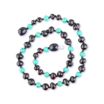 Handmade black and turquoise bead necklace with focal bead, stylish and versatile jewelry accessory.