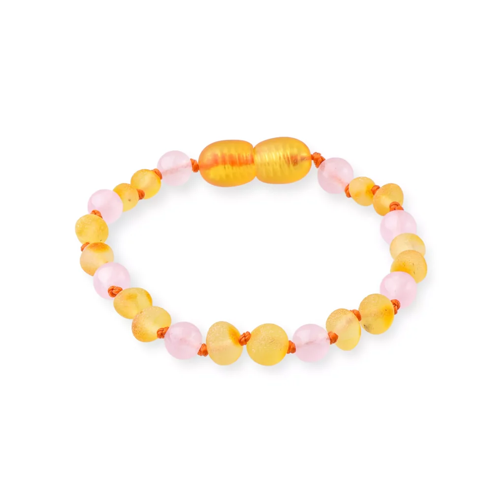 Pastel beaded bracelet with pink and yellow circular and faceted beads, elastic stretch.