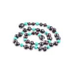 Elegant black and turquoise beaded necklace with glossy and matte textures for versatile style.